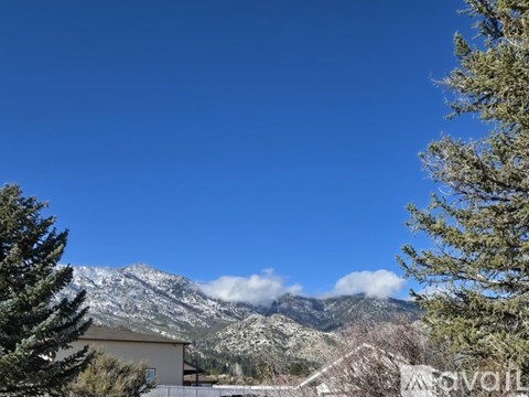 A mountain range covered in snow under a clear blue sky.