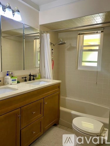 A bathroom with a toilet, sink, and bathtub.