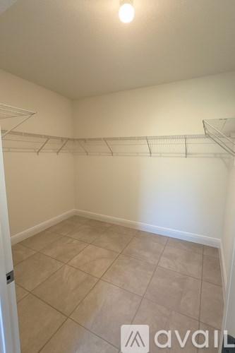 Empty room with a shelf and tiled floor.
