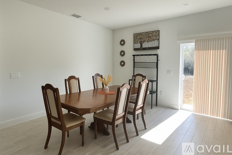 A dining room with a wooden table and chairs.