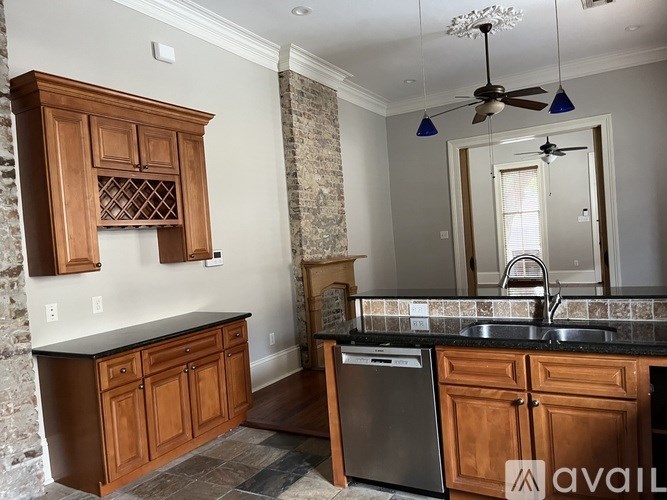 A kitchen with wooden cabinets and a black countertop.