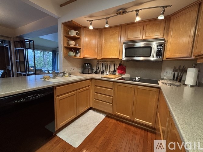 A kitchen with wooden cabinets and a white countertop.