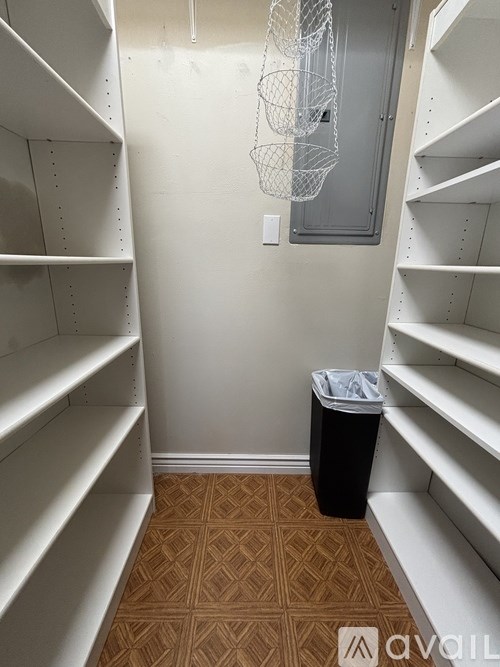 A long hallway with a trash can in the middle.