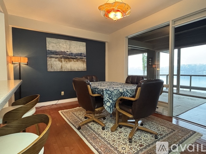 A dining room with a table and chairs.