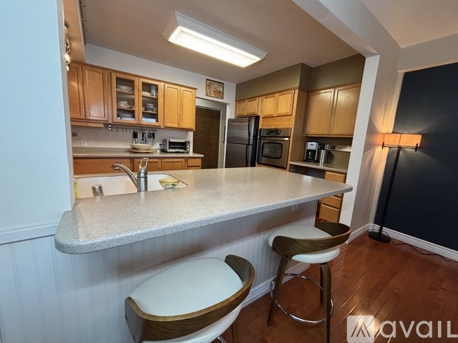 A kitchen with wooden cabinets and a white countertop.
