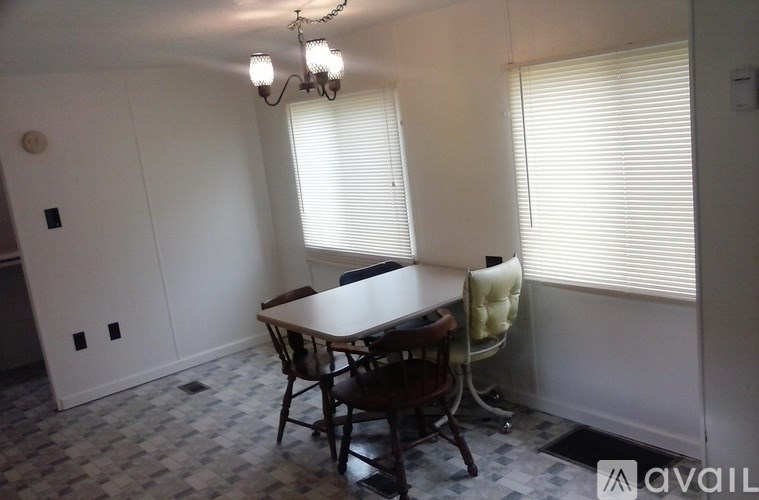 A room with a table and chairs in it.