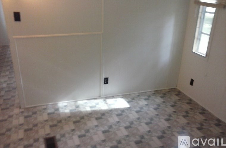 A room with a tiled floor and a window.