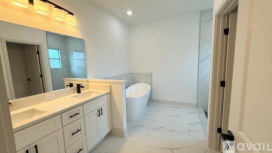 A bathroom with a marble floor and white walls.