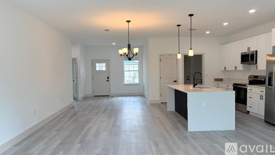 A spacious kitchen with a large island in the middle.