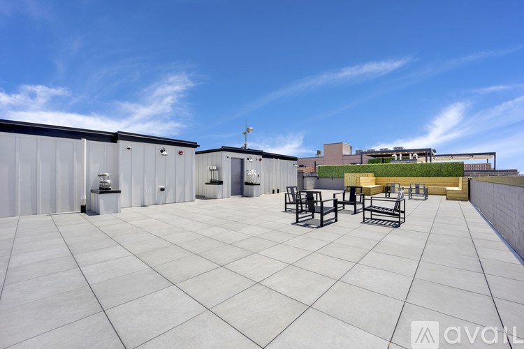 A rooftop patio with a table and chairs.