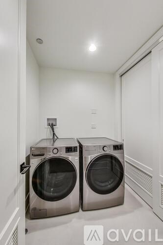 Two front loading washing machines in a laundry room.