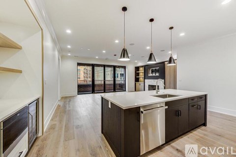 A modern kitchen with dark wood cabinets and a center island.