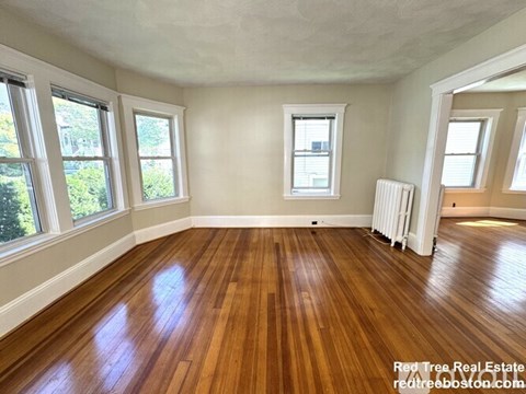 A room with wooden floors and white walls.