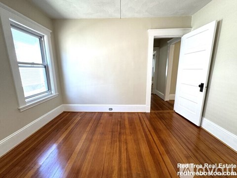 A room with wooden floors and a white door.