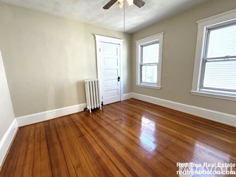 A room with wooden floors and a white door.