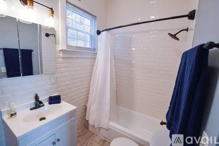 A bathroom with a white sink and a white toilet.