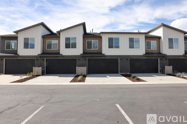 A row of houses with garages in front of them.
