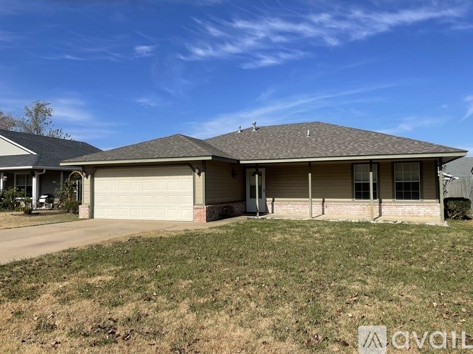 A house with a brown roof and a garage door is shown.