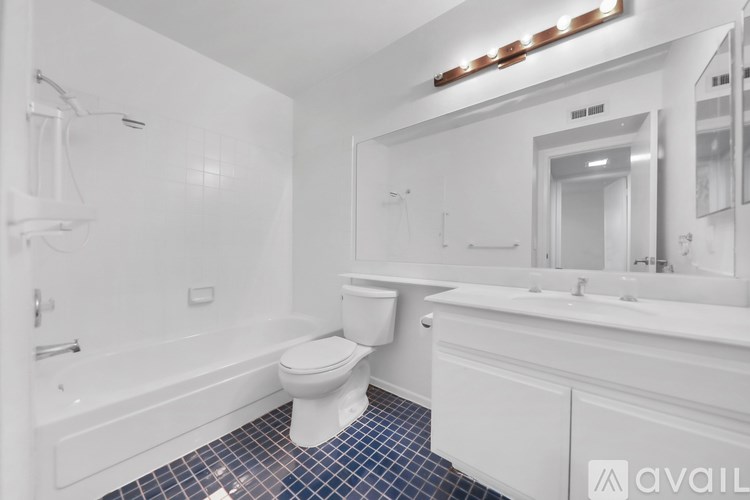 A white bathroom with a toilet, sink, and bathtub.