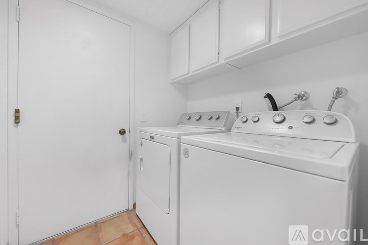 A white washing machine and dryer in a small laundry room.