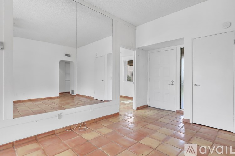 A room with a tiled floor and white walls.