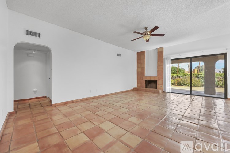 A room with a tiled floor and a ceiling fan.