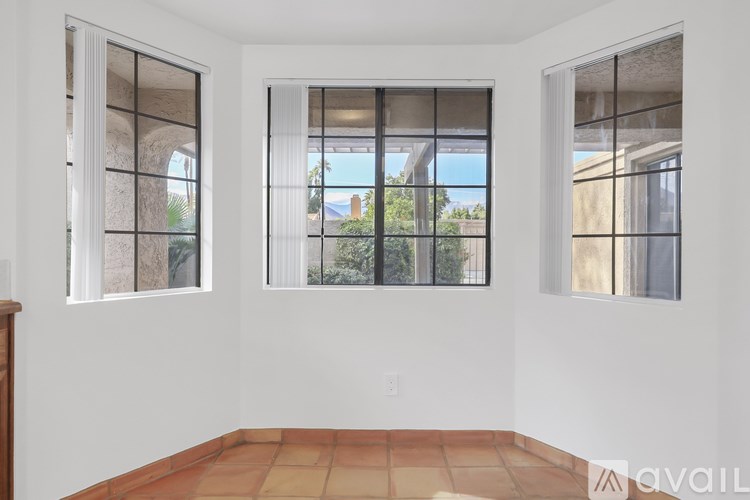 A room with two windows and a tiled floor.