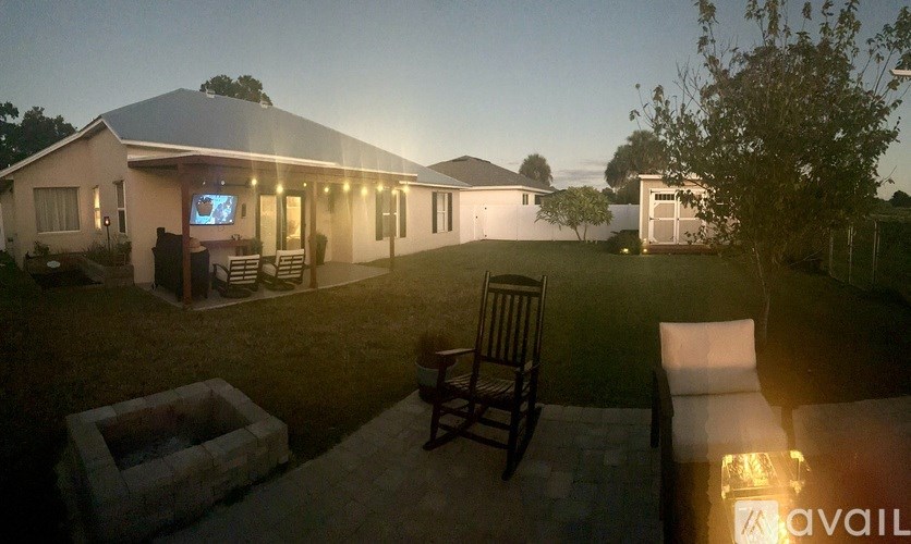 A house with a patio and a chair is shown in the image.