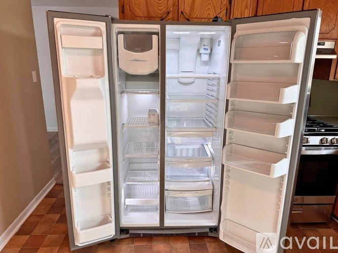 A white double door refrigerator with the door open is available for purchase.