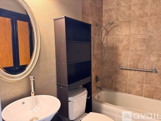 A bathroom with a sink, toilet, and bathtub.