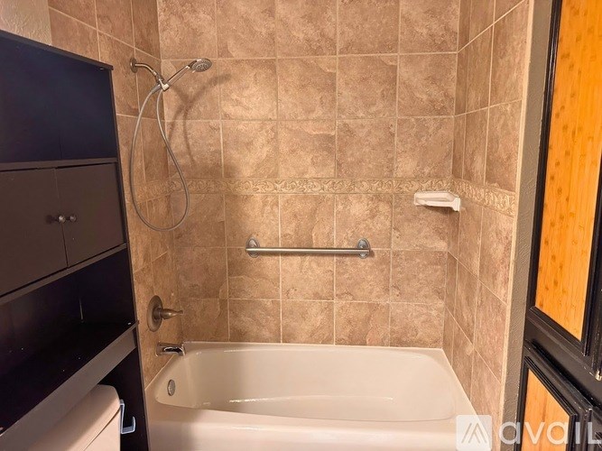 A bathroom with a tiled shower and a bathtub.
