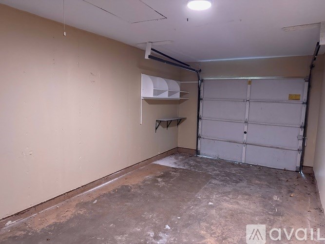 A room with a white door and a white shelf.