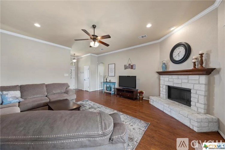 A living room with a fireplace and a television.