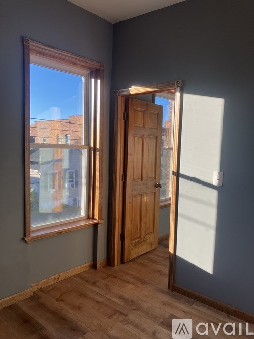 A kitchen with a stainless steel refrigerator and cabinets.