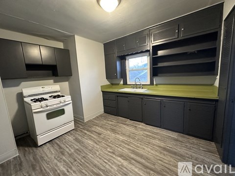 A small kitchen with a stove and a window.