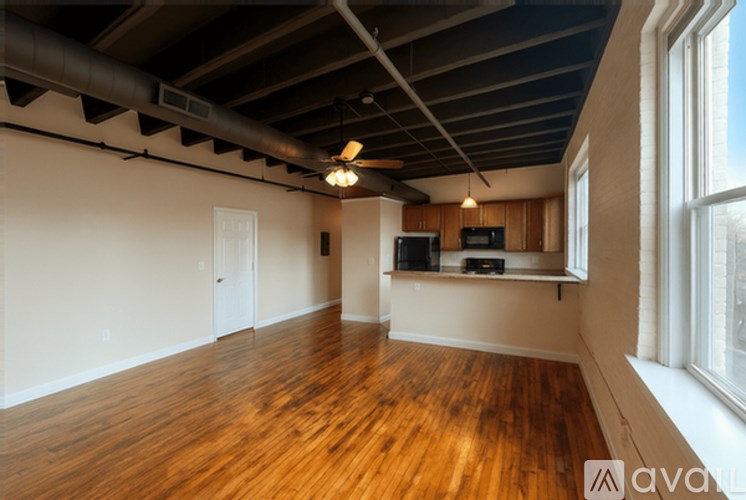 A room with wooden floors and a ceiling fan.