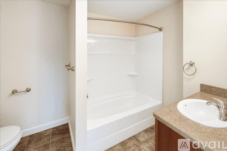 A bathroom with a toilet, sink, and bathtub.