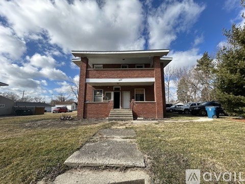 A house with a front yard and a driveway.