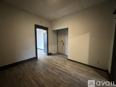 A room with a door and a wall with a sign on it.
