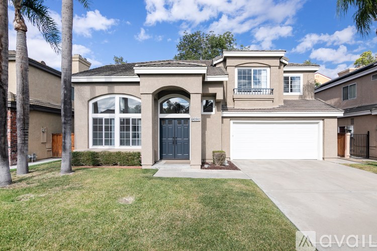 A house with a garage and a driveway is for sale.