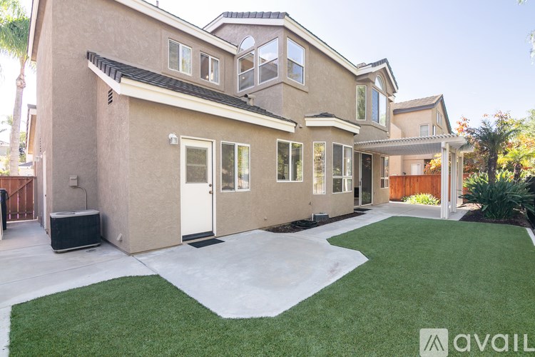 A house with a beige exterior and a white door is available for purchase.