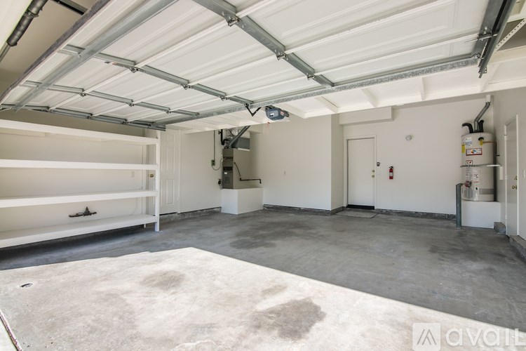 A spacious garage with a white ceiling and a concrete floor.