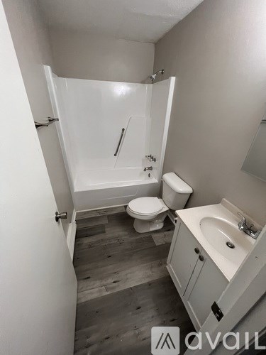 A bathroom with a toilet, sink, and bathtub.