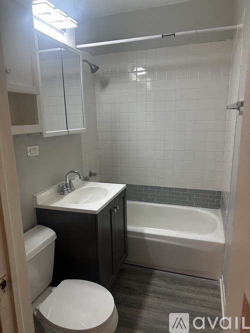 A room with a wooden floor and a white door.