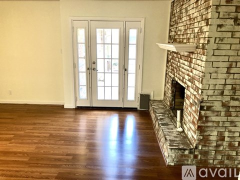 A room with a fireplace and a door with a glass panel.