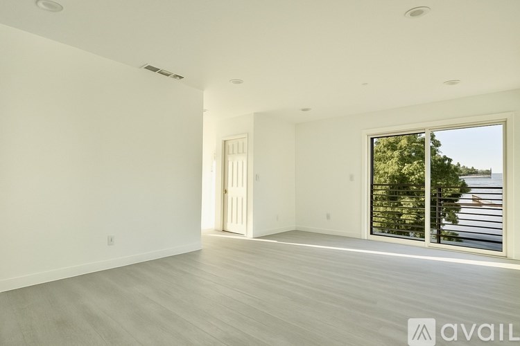 A spacious room with a door and a window.