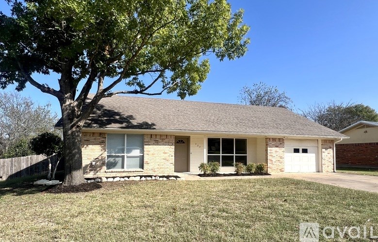 A house with a tree in front of it.