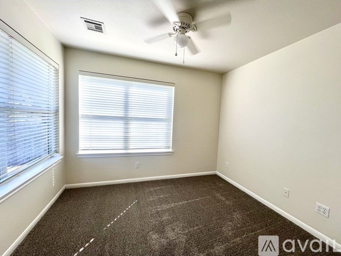 A room with a white shelving unit and a wooden floor.