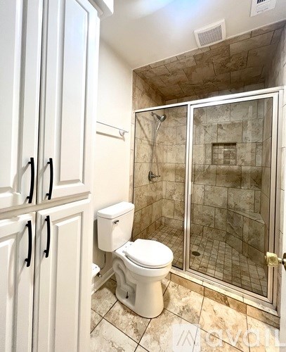 A backyard with a wooden fence and a concrete slab.