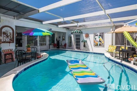 A pool with a blue tiled edge and a white tiled floor.